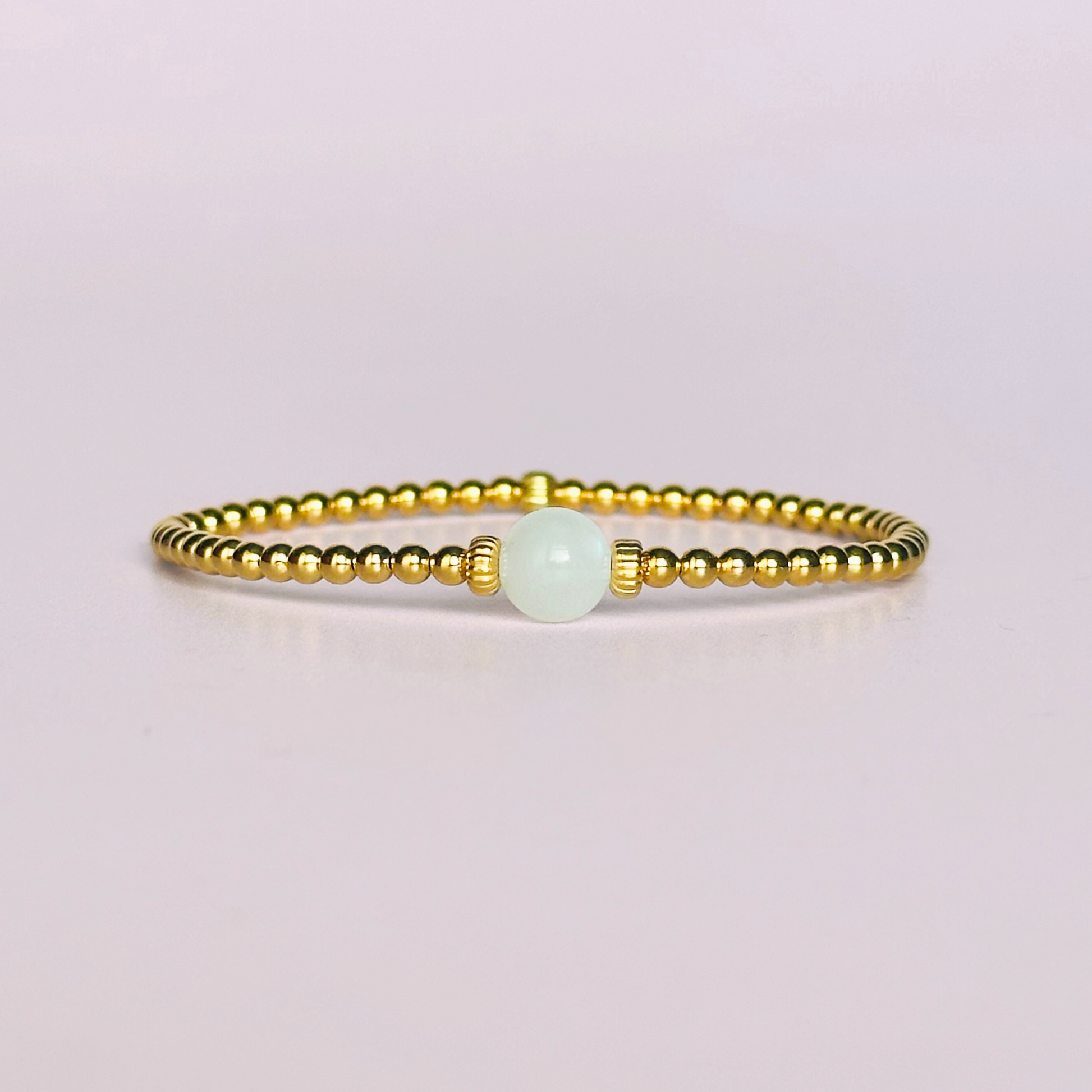 Gold vermeil moonstone bracelet features an ethically mined 8mm moonstone bead, flanked by corrugated rondelle beads on a band of 3mm gold vermeil beads. A bracelet to promote feminine energy and intuition.