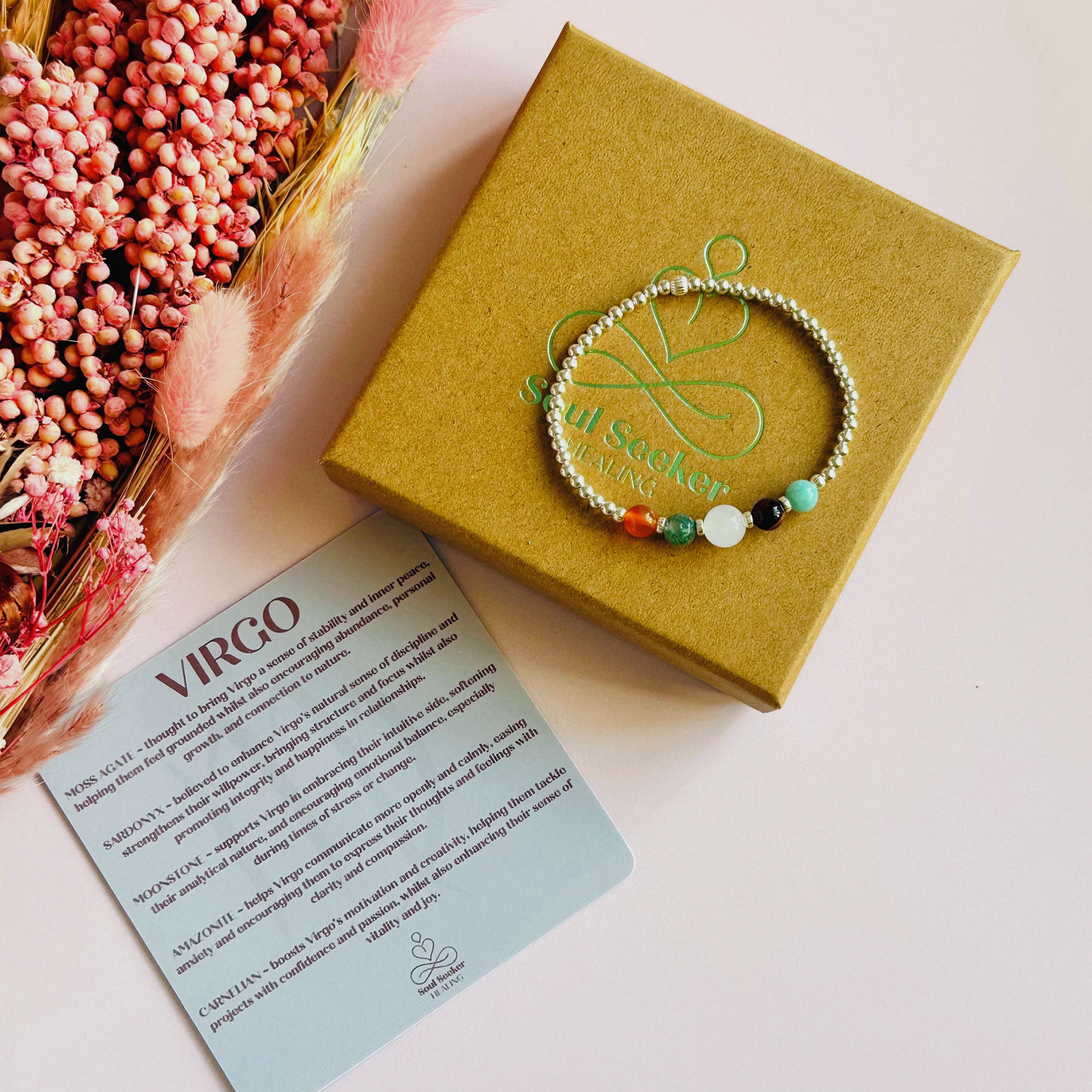 This sterling silver Virgo bracelet is made with a selection of five healing crystals all believed to resonate with the Virgo zodiac sign. The central bead is 8mm, the other four are 6mm. On an elasticated band of 3mm sterling silver beads with corrugated accent beads. Featuring amazonite, carnelian, moonstone, moss agate and sardonyx.