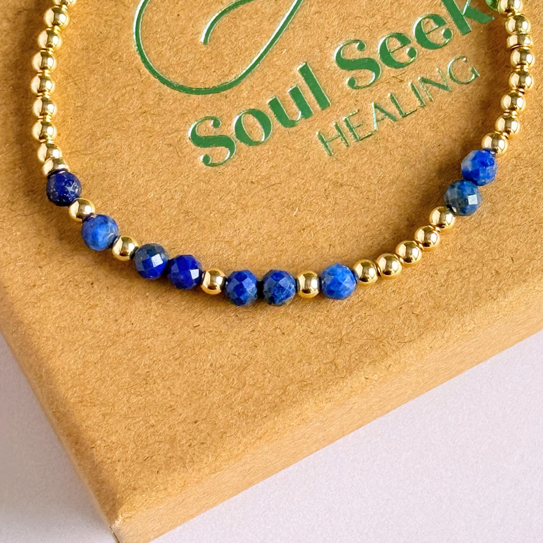 Morse code secret message bracelet spelling out your chosen name in gold filled and lapis lazuli crystal beads. Elasticated with 4mm faceted lapis lazuli beads and 3mm gold filled beads. Custom September birthstone bracelet.