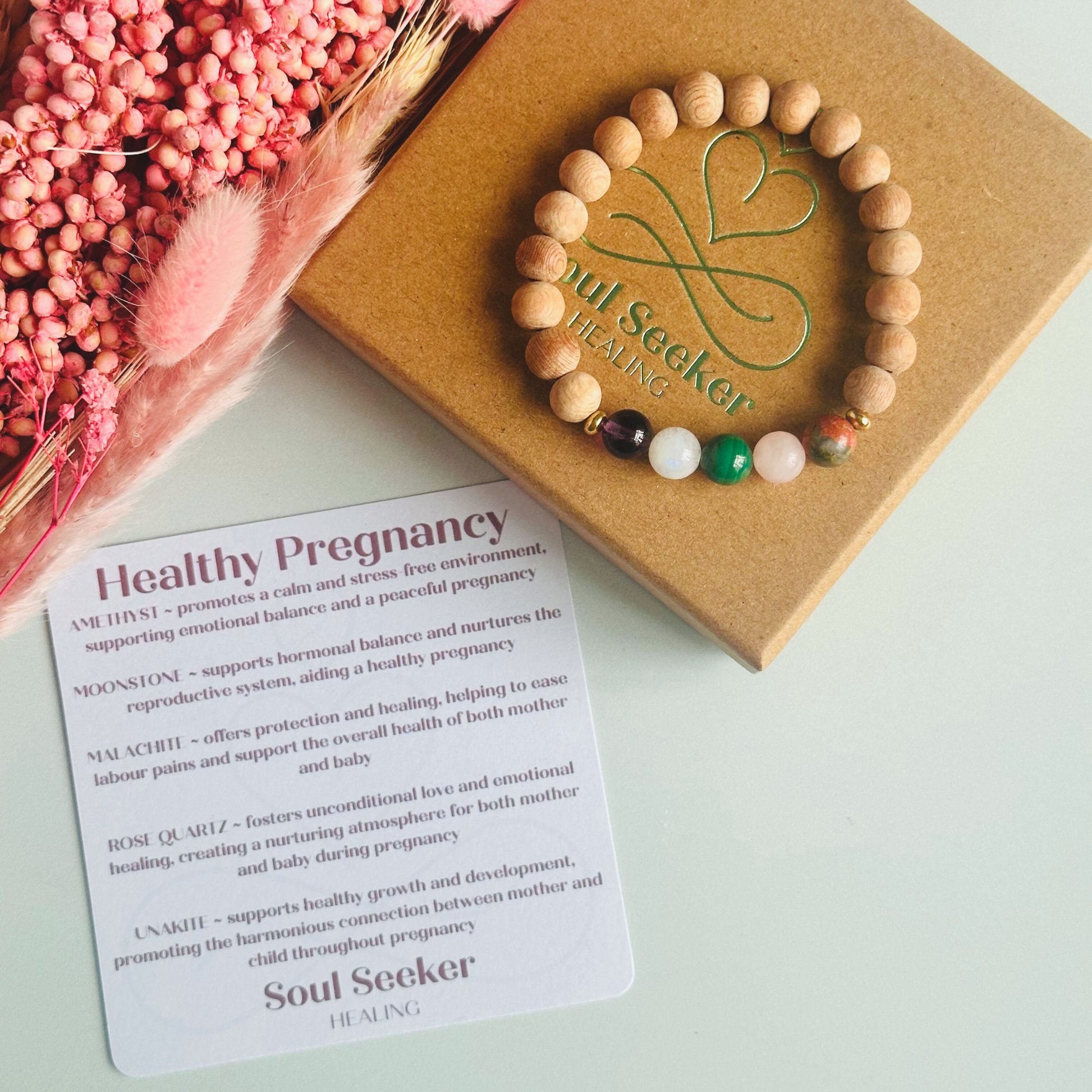 Essential oil diffuser bracelet featuring five crystal beads, all thought to aid in having a healthy pregnancy. Featuring unakite, rose quartz, amethyst, malachite and moonstne with raw rosewood beads that can act as a diffuser for essential oils.