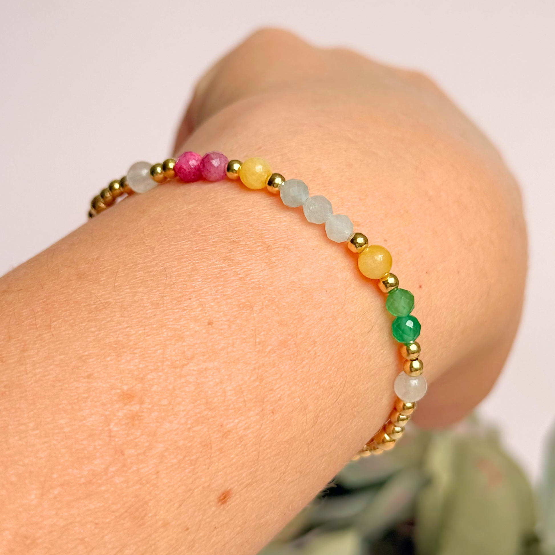 'Amalfi Coast' gold vermeil dainty beaded bracelet with green agate, yellow calcite, pink tourmaline, aquamarine and moonstone. Made with round 3mm gold vermeil beads and 4mm smooth and faceted round crystal gemstone beads. Pictured being worn, on an angle