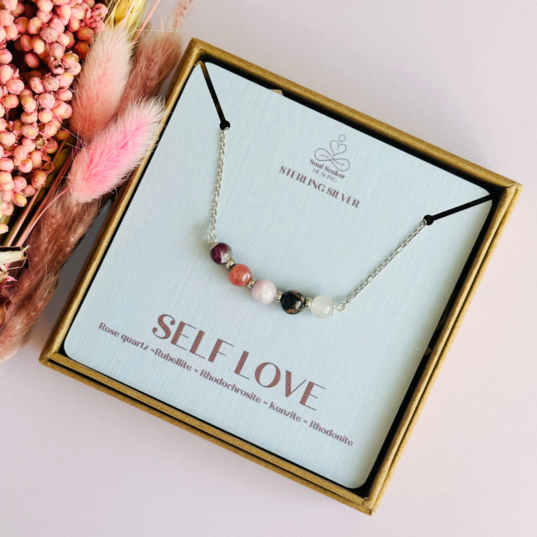 A dainty self love crystal necklace made with a selection of five healing crystals all believed to help promote self love. On a fine, sterling silver figaro chain, which fastens with a sterling silver bolt clasp. Featuring corrugated sterling silver spacer beads and accented with daisy shaped bead caps.