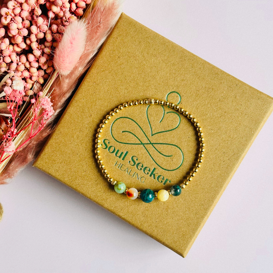This gold vermeil Gemini bracelet is made with a selection of five healing crystals all believed to resonate with the Gemini zodiac sign. The central bead is 8mm, the other four are 6mm. On an elasticated band of 3mm gold vermeil beads with corrugated accent beads. Featuring chrysocolla, dendritic agate, apatite, yellow calcite and moss agate.