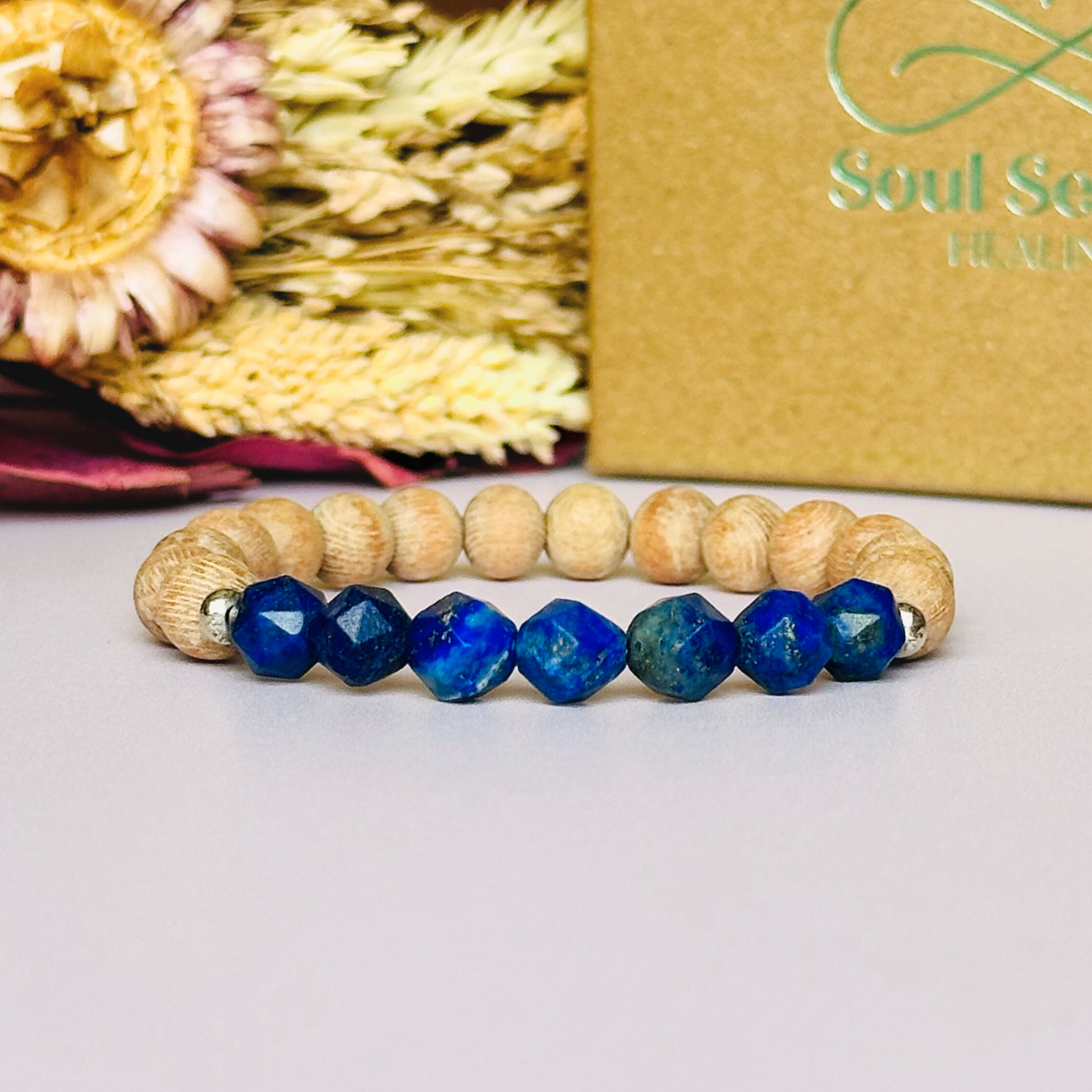 Lapis lazuli and raw rosewood elasticated essential oil diffuser bracelet. Made with 8mm star cut lapis lazuli beads, 8mm round raw rosewood beads and your choice of sterling silver, gold vermeil or rose gold vermeil spacer beads