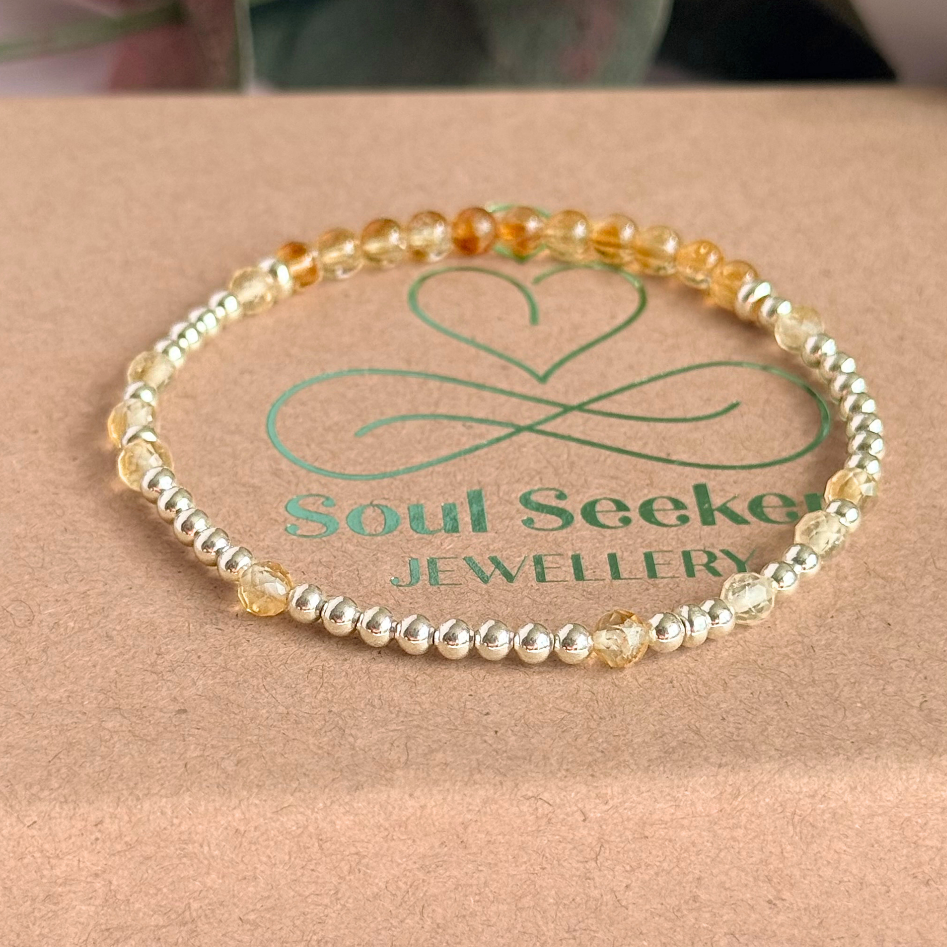 Citrine morse code bracelet that spells out the words ‘Ask, believe, receive’ in a combination of 4mm round smooth and faceted crystal beads with your choice of sterling silver or gold vermeil accent beads. Pictured on the box, in silver