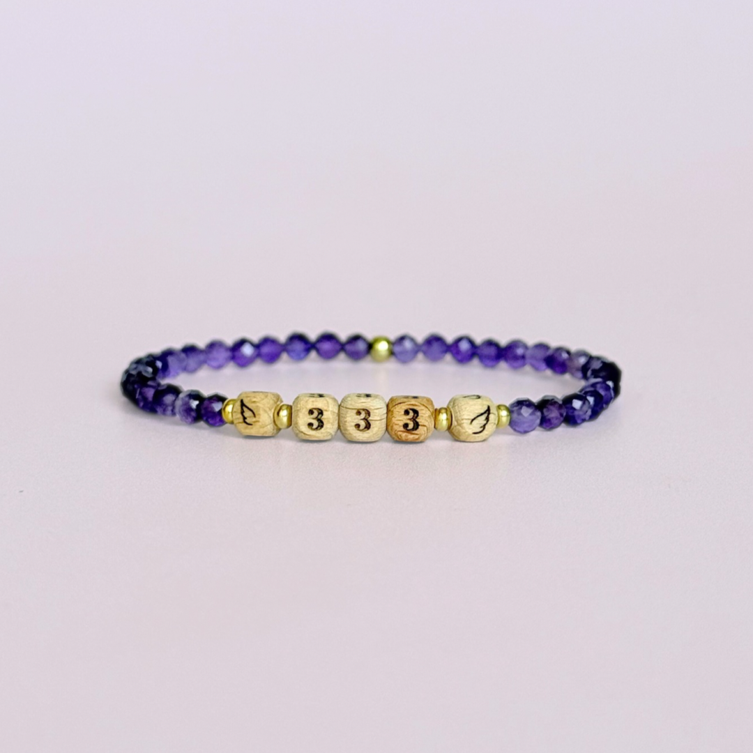Bracelet featuring engraved wooden 333 angel number and wing beads, on the band of 4mm faceted amethyst round crystal gemstone beads. Finished with your choice of gold vermeil, sterling silver or rose gold vermeil accent beads.