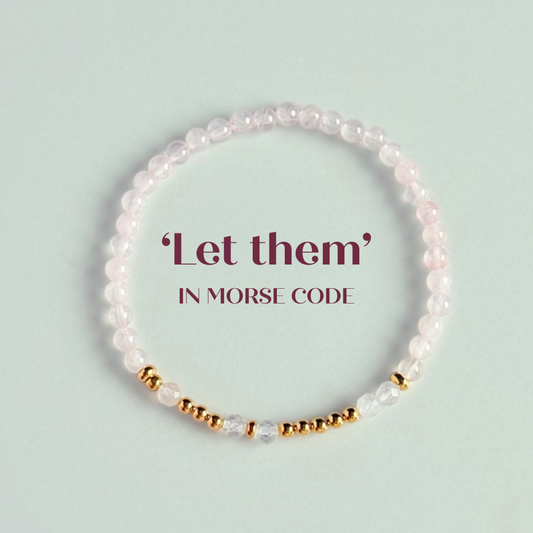 Rose quartz crystal morse code bracelet that spells out the words ‘Let them’ in a combination of 4mm round rose quartz beads, 4mm faceted rose quartz beads and either sterling silver or gold vermeil 3mm round beads. The words start and end at the rondelle spacer beads.


