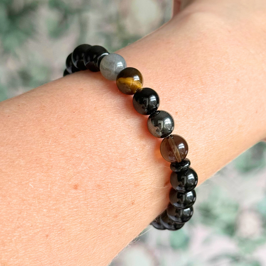 Men’s grief support bracelet featuring 8mm crystal beads which are believed to help with the various aspects of grief and loss. Includes black obsidian, black onyx, labradorite, tigers eye, hematite and smoky quartz.
