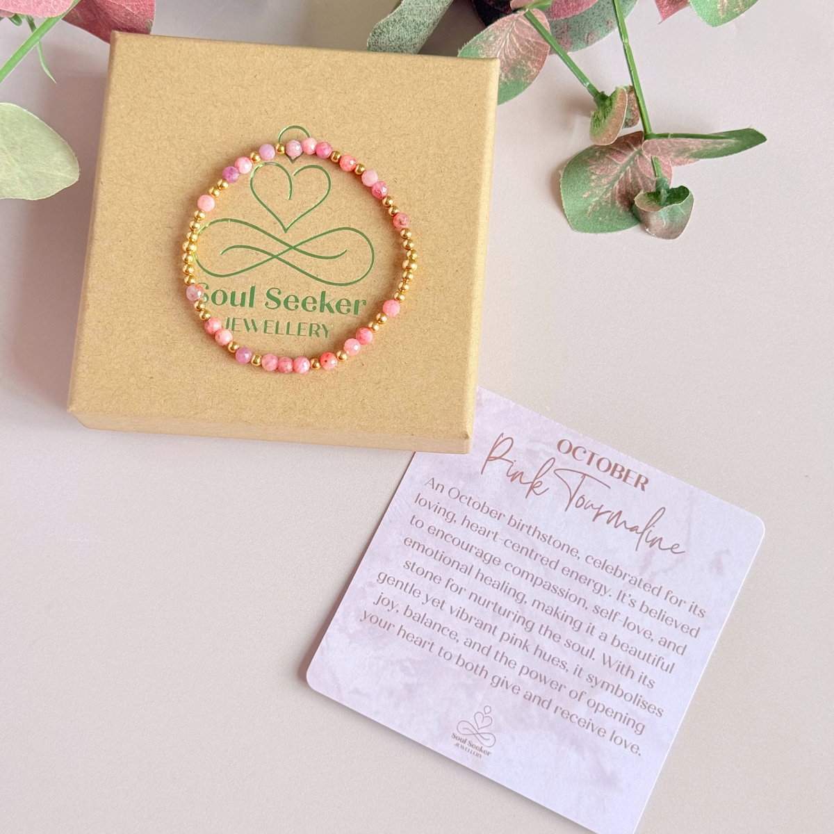 Dainty, minimalist gold vermeil and pink tourmaline October birthstone stacking bracelet. Made with 4mm faceted pink tourmaline beads and 3mm gold vermeil round beads. Elasticated for comfort. Pictured on top of the box, with the crystal information card