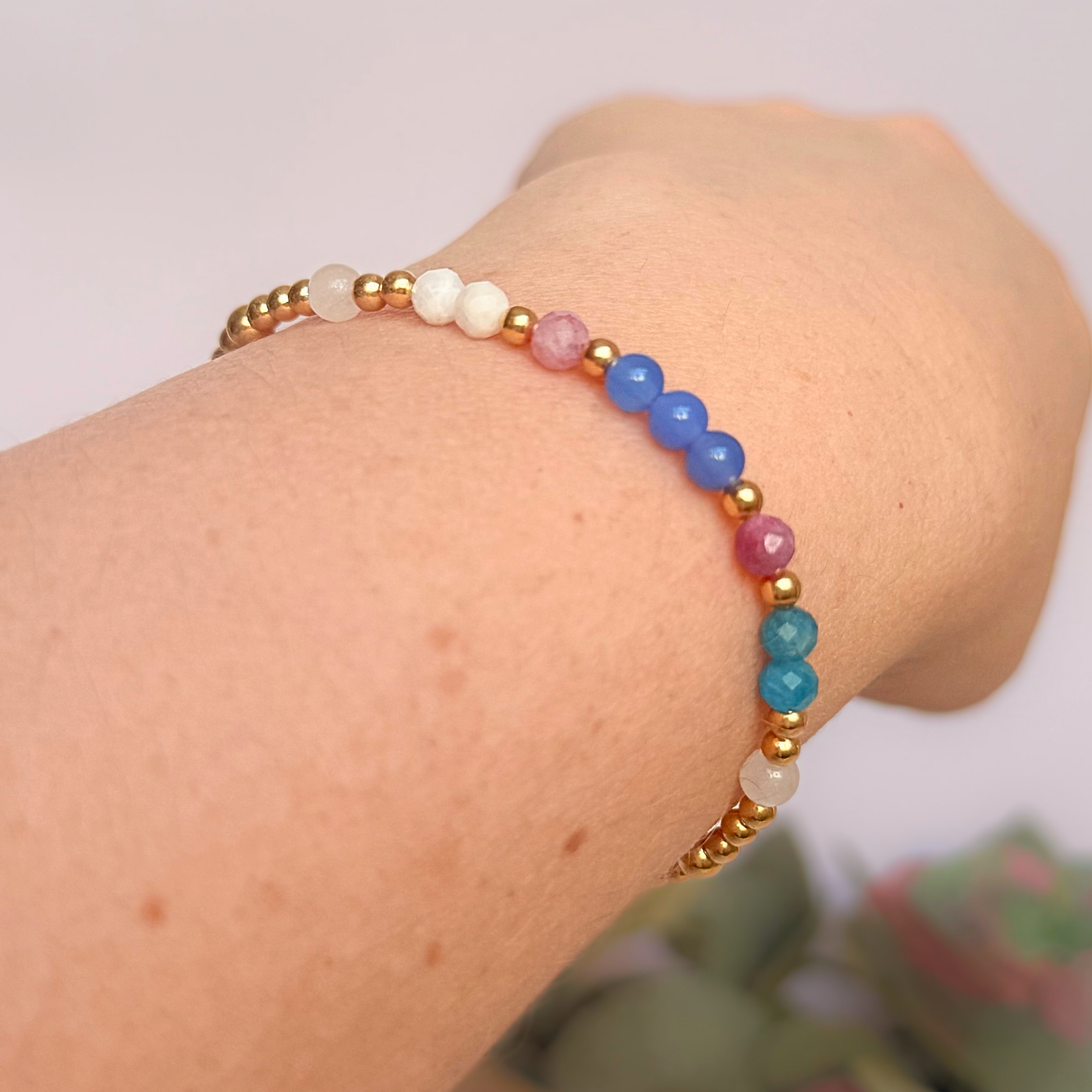 ‘Santorini' gold vermeil dainty beaded bracelet with pink tourmaline, rainbow moonstone, blue agate, apatite and white jade. Made with round 3mm gold vermeil beads and 4mm smooth and faceted round crystal gemstone beads. Pictured being worn, at an angle