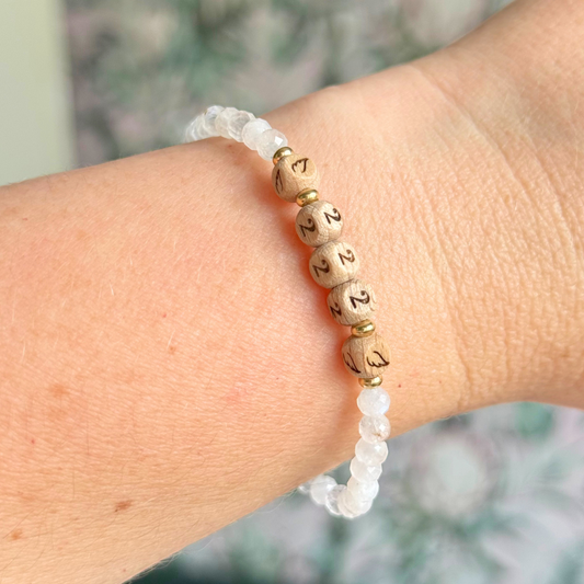 Bracelet featuring engraved wooden 222 angel number and wing beads, on the band of 4mm faceted moonstone round crystal gemstone beads. Finished with your choice of gold vermeil, sterling silver or rose gold vermeil accent beads.