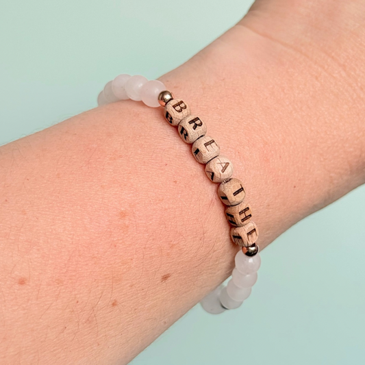 Breathwork bracelet featuring 6mm and 8mm frosted rose quartz crystal beads that follow the 4-7-8 counted breathing method. Also featuring laser engraved wooden letter beads spelling out the word BREATHE. Choose your accent beads from rose gold vermeil, gold vermeil or sterling silver.