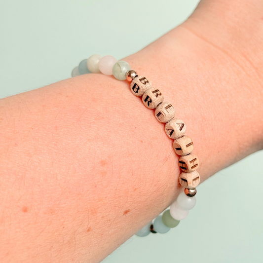 Breathwork bracelet featuring 6mm and 8mm frosted crystal beads that follow the 4-7-8 counted breathing method. Also featuring laser engraved wooden letter beads spelling out the word BREATHE. Choose your accent beads from rose gold vermeil, gold vermeil or sterling silver.