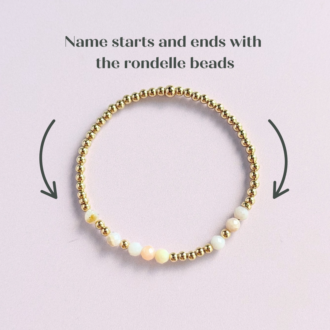 Morse code secret message bracelet spelling out your chosen name in gold filled and pink opal crystal beads. Elasticated with 4mm faceted pink opal beads and 3mm gold filled beads. Custom October birthstone bracelet.