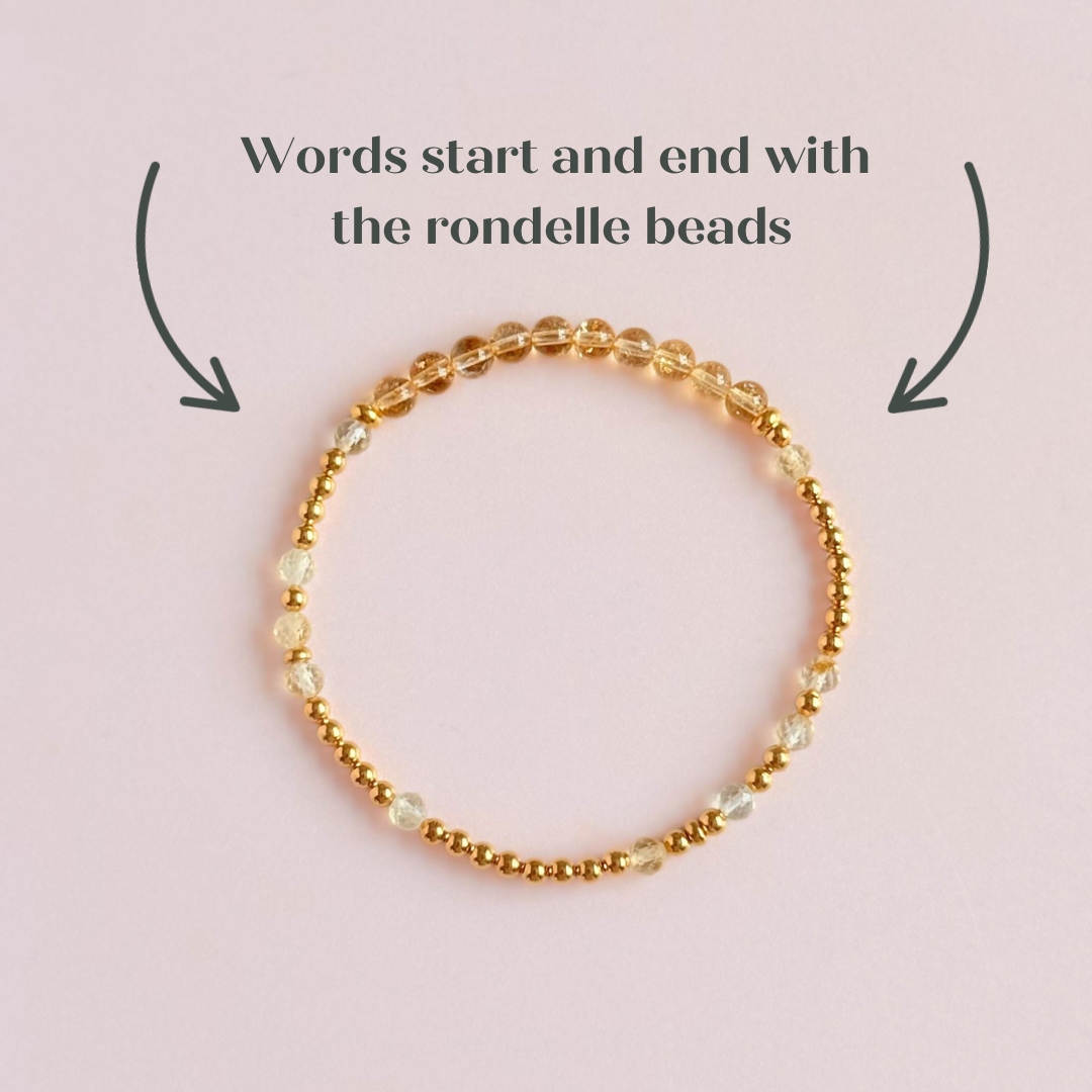 Citrine morse code bracelet that spells out the words ‘Ask, believe, receive’ in a combination of 4mm round smooth and faceted crystal beads with your choice of sterling silver or gold vermeil accent beads. Pictured in gold, from above, showing where the words start and finish on the bracelet.