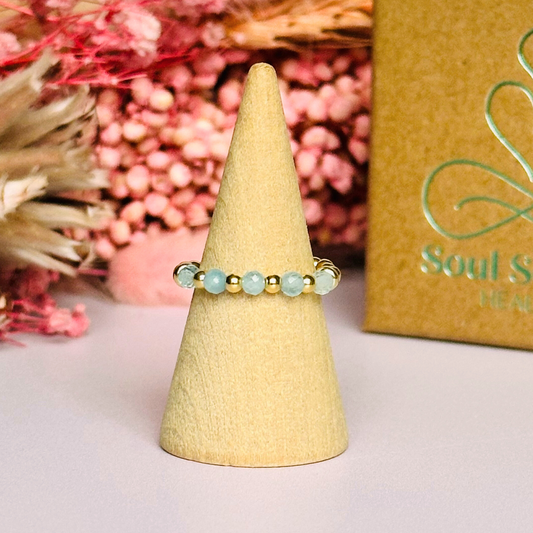 Gold vermeil aquamarine ring featuring five 3mm faceted round aquamarine beads on a elasticated ring band of 2.5mm gold vermeil beads. March birthstone ring.