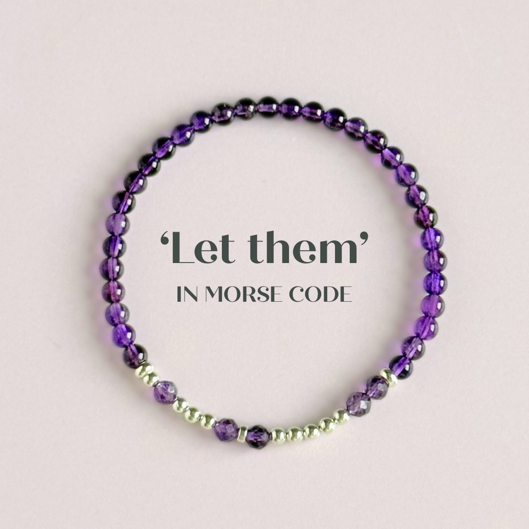 Amethyst crystal morse code bracelet spells out the words ‘Let them’ in amethyst beads