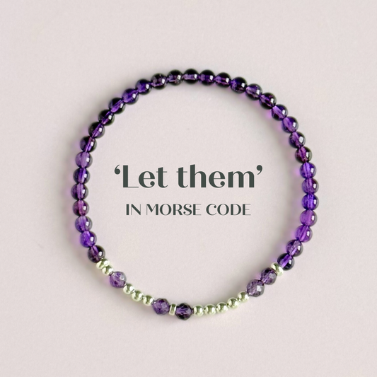 Amethyst crystal morse code bracelet spells out the words ‘Let them’ in amethyst beads
