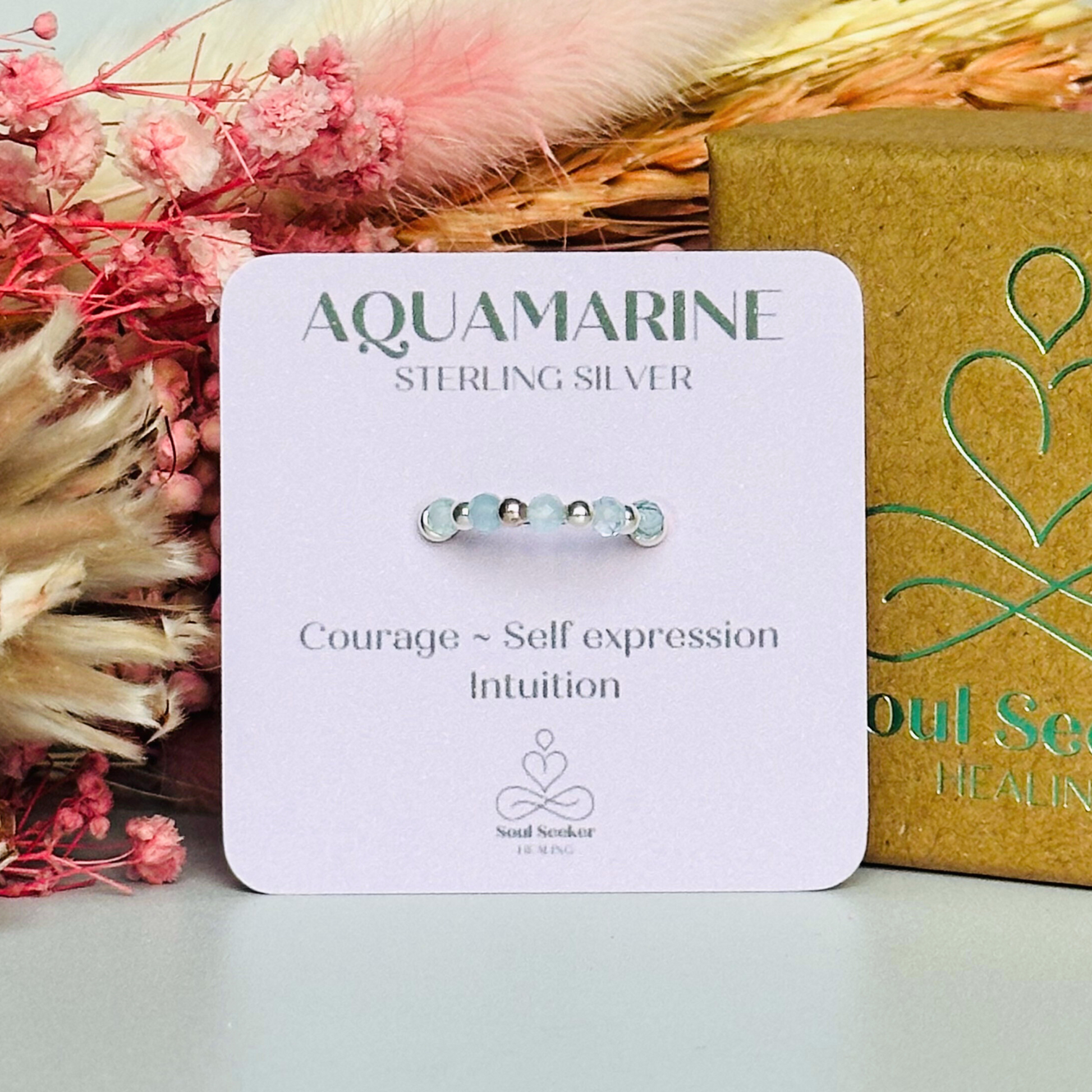 Sterling silver aquamarine ring featuring five 3mm faceted round aquamarine beads on a elasticated ring band of 2.5mm gold vermeil beads. March birthstone ring.
