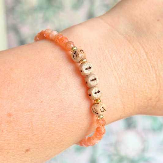 Bracelet featuring engraved wooden 111 angel number and wing beads, on the band of 4mm faceted sunstone round crystal gemstone beads. Finished with your choice of gold vermeil, sterling silver or rose gold vermeil accent beads.