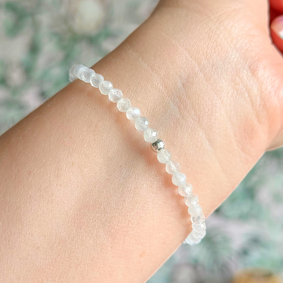Bracelet featuring engraved wooden 222 angel number and wing beads, on the band of 4mm faceted moonstone round crystal gemstone beads. Finished with your choice of gold vermeil, sterling silver or rose gold vermeil accent beads.