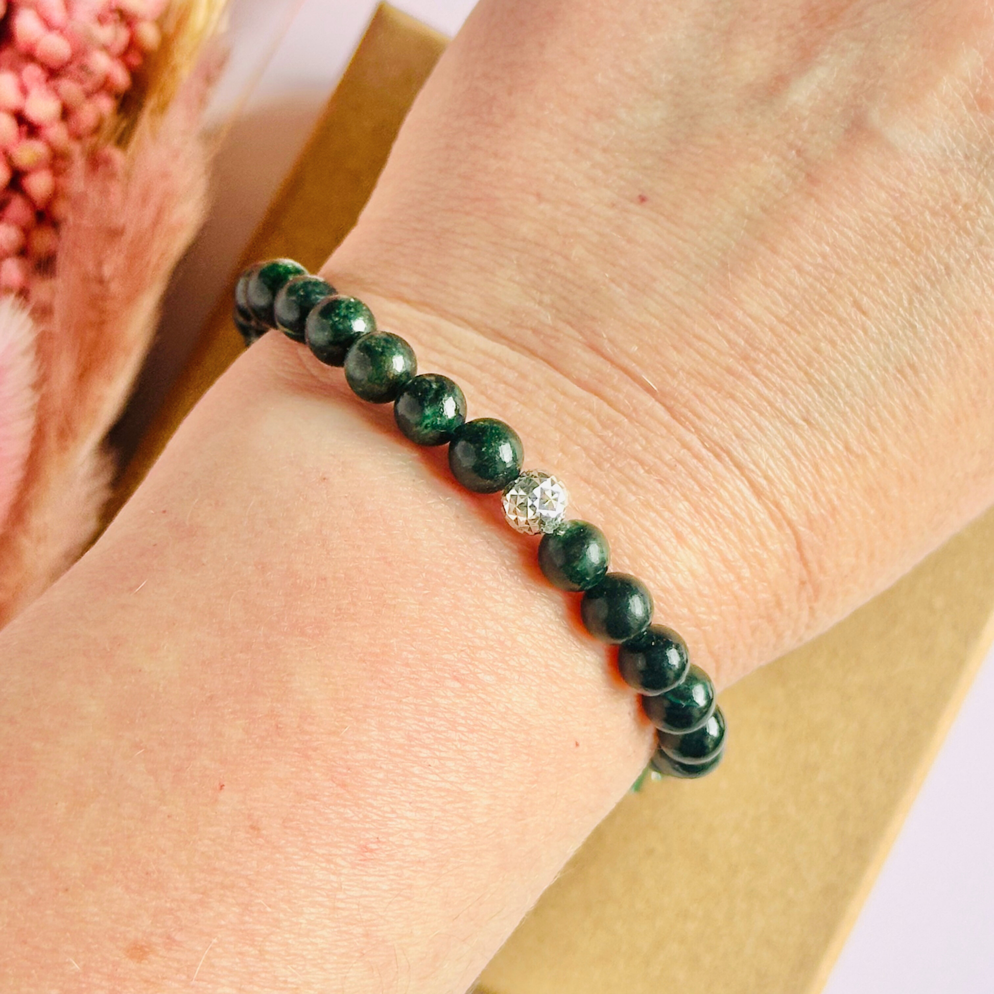 Crystal healing bracelet featuring a band of 6mm, dark Emerald genuine round beads with one 6mm faceted bead as a focal point, in either sterling silver or gold vermeil. Elasticated for comfort