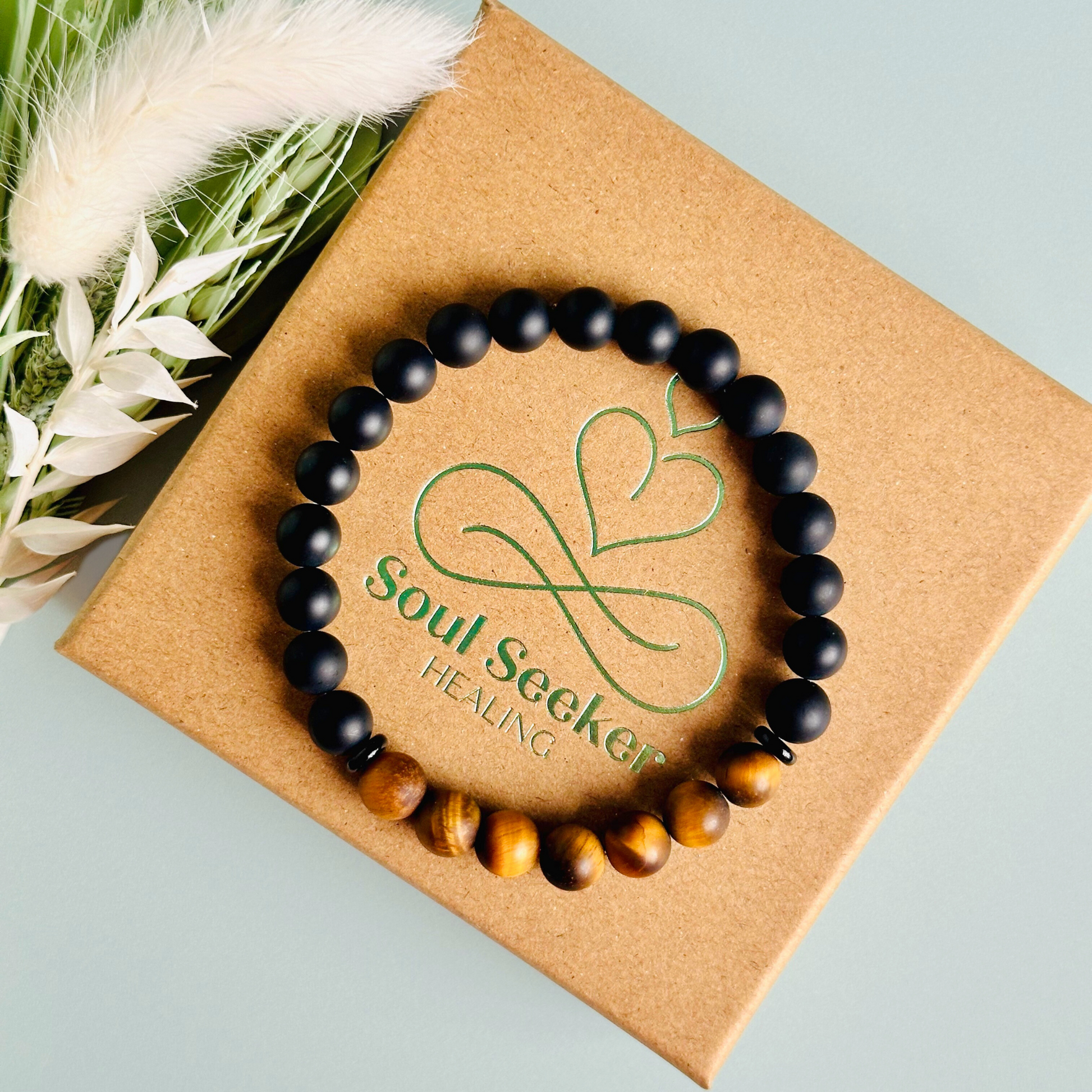 Men’s crystal bracelet featuring 8mm matte black onyx beads, 8mm matte tigers eye beads with black agate spacer beads.