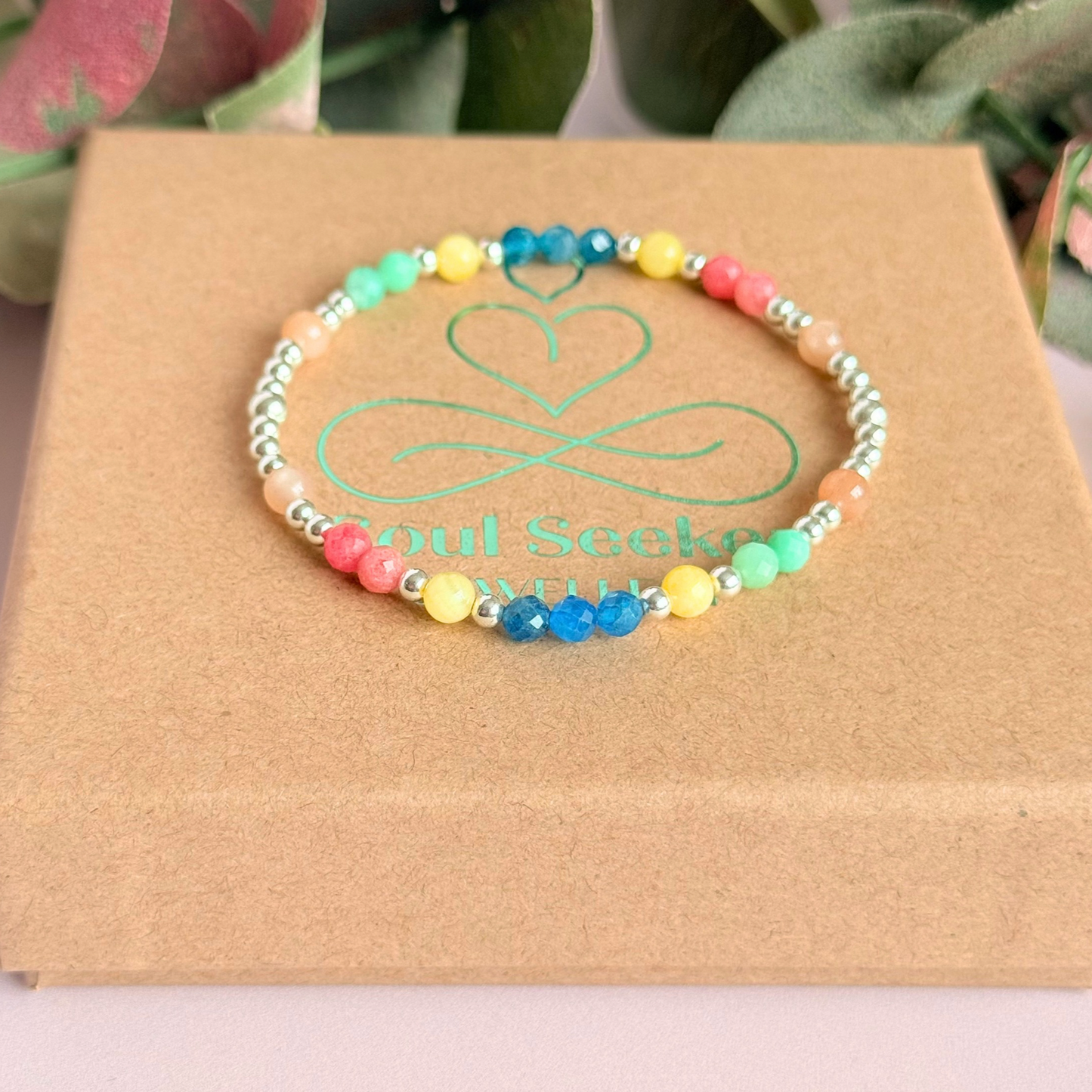 'Key West' sterling silver dainty beaded bracelet with apatite, rhodochrosite, yellow calcite, chrysoprase and peach moonstone. Made with round 3mm sterling silver beads and 4mm smooth and faceted round crystal gemstone beads. Pictured on top of the gift box 