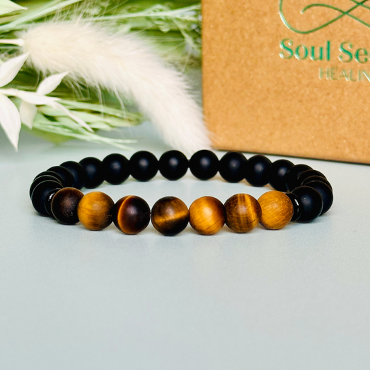 Men’s crystal bracelet featuring 8mm matte black onyx beads, 8mm matte tigers eye beads with black agate spacer beads.￼