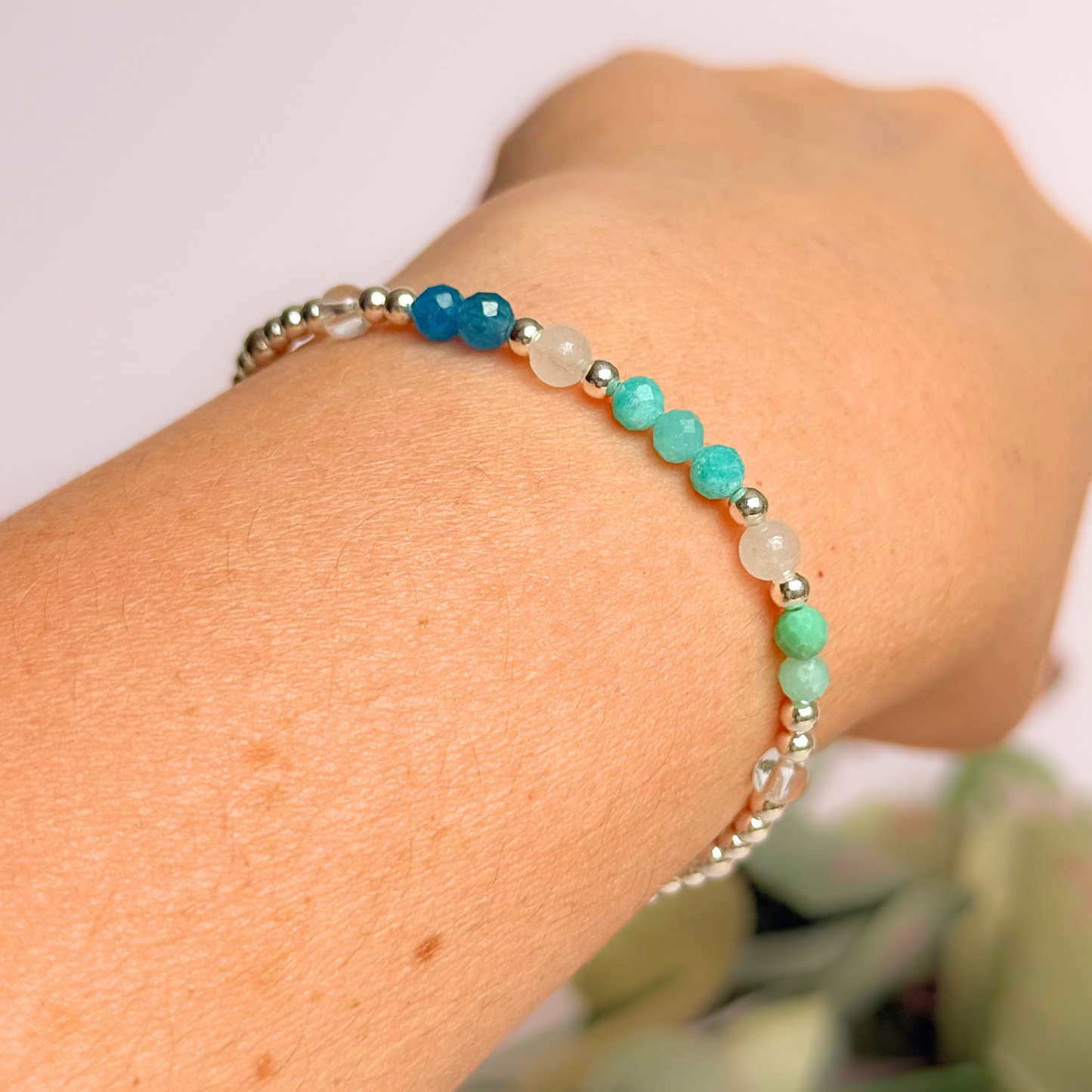 ‘Caribbean Dream' sterling silver dainty beaded bracelet with white jade, chrysoprase, amazonite, apatite and clear quartz. Made with round 3mm sterling silver beads and 4mm smooth and faceted round crystal gemstone beads. Pictured being worn, at an angle