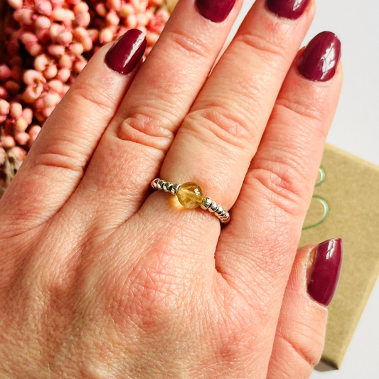 Citrine ring featuring a 6mm round citrine bead, flanked by sterling silver rondelle beads on a sterling silver elasticated band. November birthday ideas, November birthday gift, November birthstone ring, November jewellery, born in November