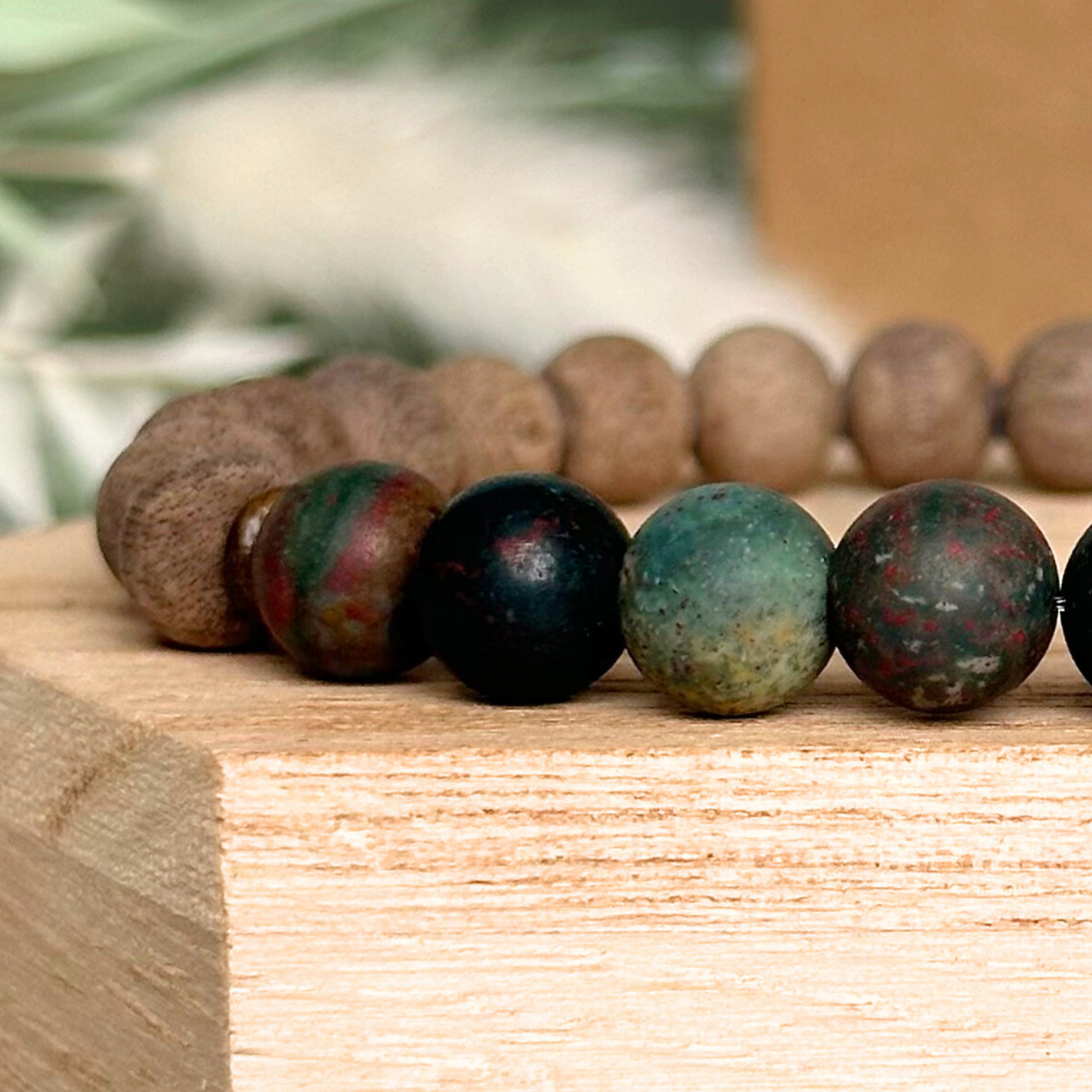 Men’s crystal bracelet featuring 8mm matte bloodstone beads, 8mm raw greywood beads with sandalwood spacer beads.