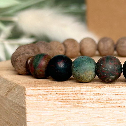Men’s crystal bracelet featuring 8mm matte bloodstone beads, 8mm raw greywood beads with sandalwood spacer beads.