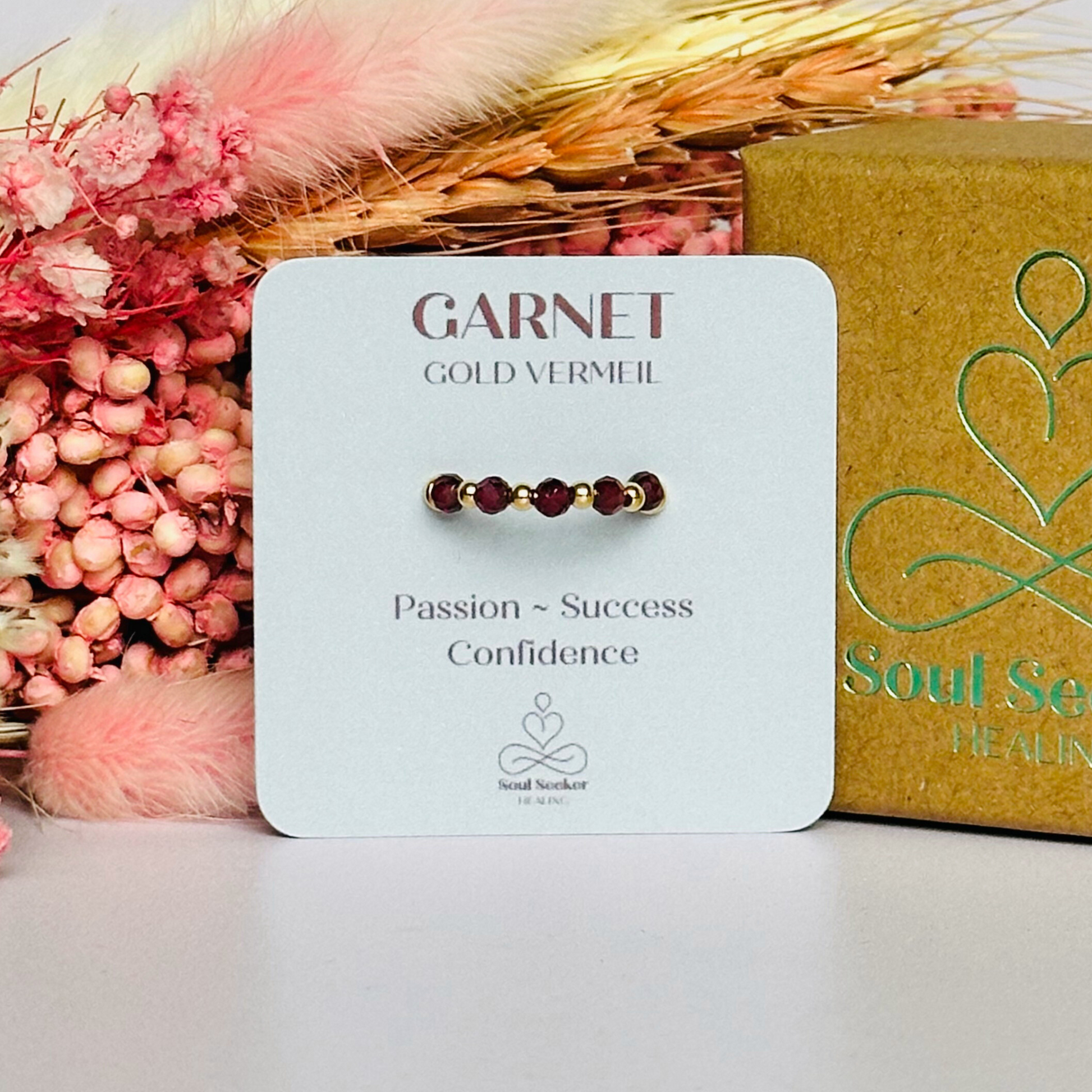 Gold vermeil garnet ring featuring five 3mm faceted round garnet beads on a elasticated ring band of 2.5mm gold vermeil beads.