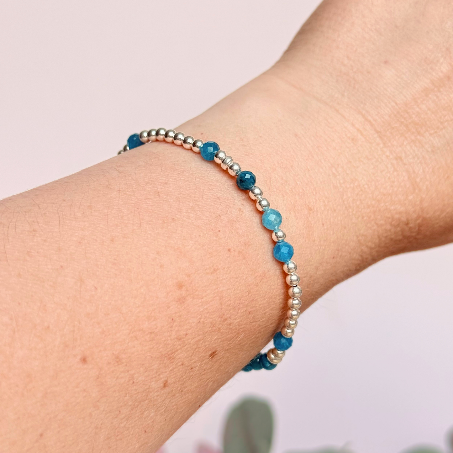 Apatite morse code bracelet that spells out the words ‘Ask, believe, receive’ in a combination of 4mm round smooth and faceted crystal beads with your choice of sterling silver or gold vermeil accent beads. Pictured in silver, being worn