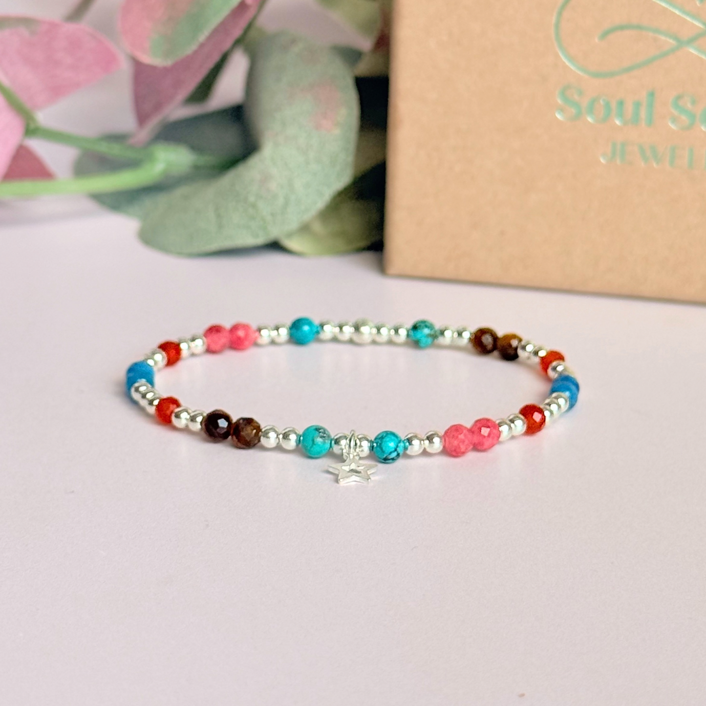 'Hot girl summer' sterling silver dainty beaded bracelet with tigers eye, turquoise, apatite, carnelian and rhodochrosite. With a beautiful open star charm. Made with round 3mm sterling silver beads and 4mm smooth and faceted round crystal gemstone beads. Pictured in front of the gift box.