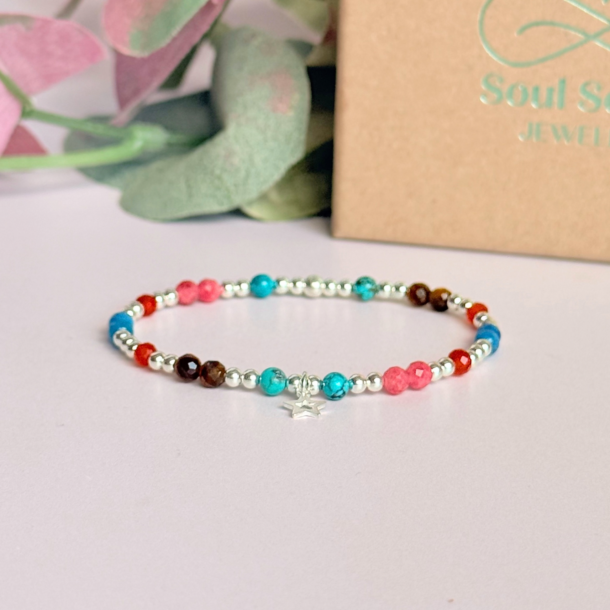 'Hot girl summer' sterling silver dainty beaded bracelet with tigers eye, turquoise, apatite, carnelian and rhodochrosite. With a beautiful open star charm. Made with round 3mm sterling silver beads and 4mm smooth and faceted round crystal gemstone beads. Pictured in front of the gift box.