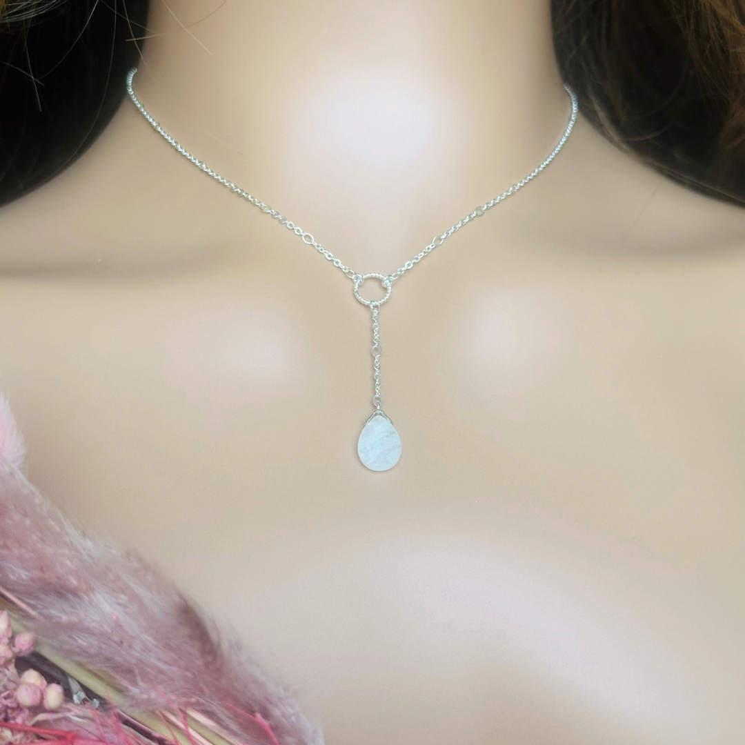 Moonstone necklace features a faceted moonstone teardrop bead on a delicate sterling silver figaro chain with a twisted sterling silver ring focal point. The necklace fastens with a subtle yet secure sterling silver bolt clasp. The teardrop bead measures 12mm x 8mm.