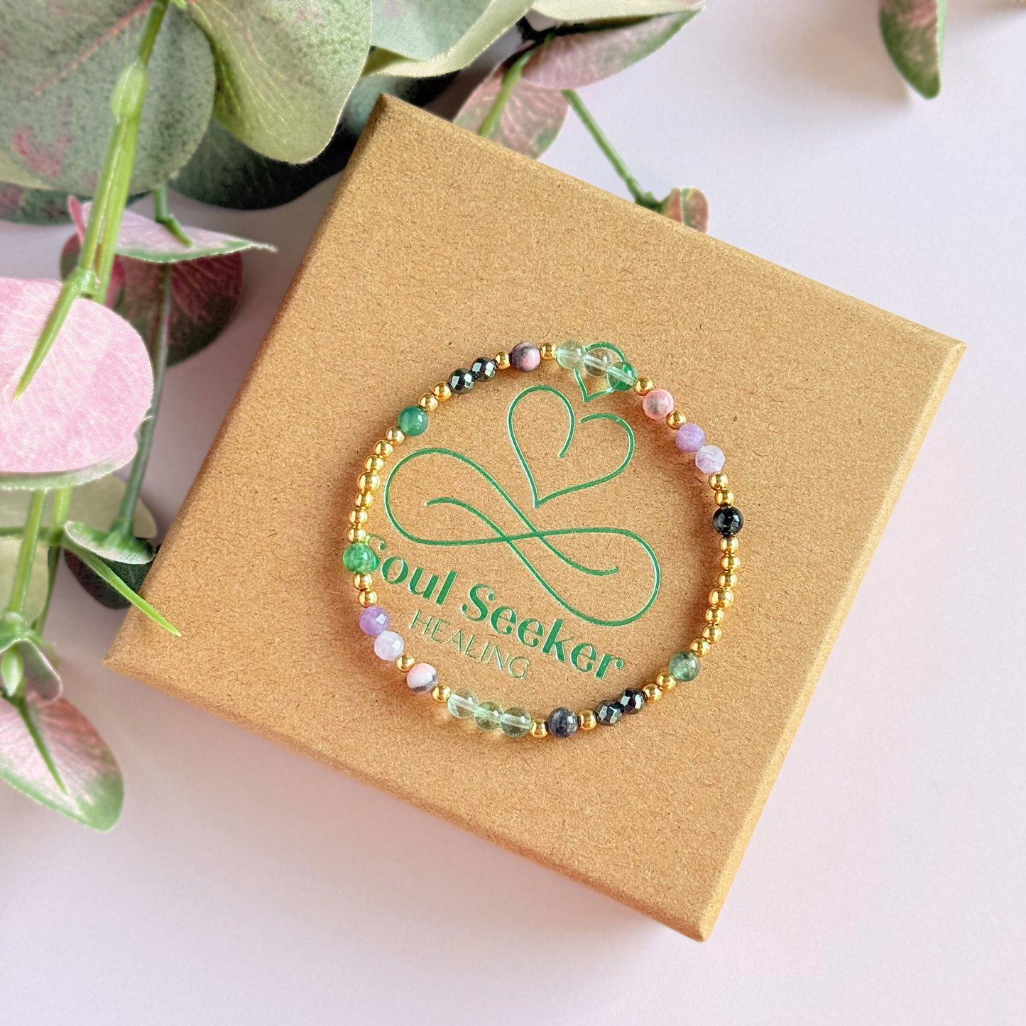 Dainty crystal bracelet featuring five crystals all believed to help with focus, clarity and overwhelm. Featuring fluorite, hematite, lepidolite, moss agate and pink zebra jasper. Featuring 3mm gold vermeil round beads and 4mm faceted round and smooth round crystal beads. Pictured on top of the gift box.￼