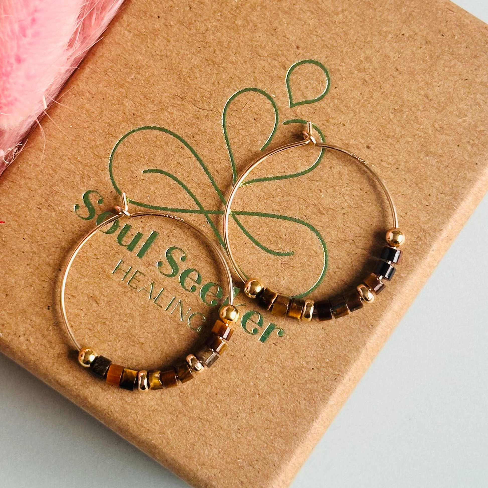 Tigers eye gold filled hoop earrings with ethically mined tigers eye heishi beads on 25mm gold filled hoops.