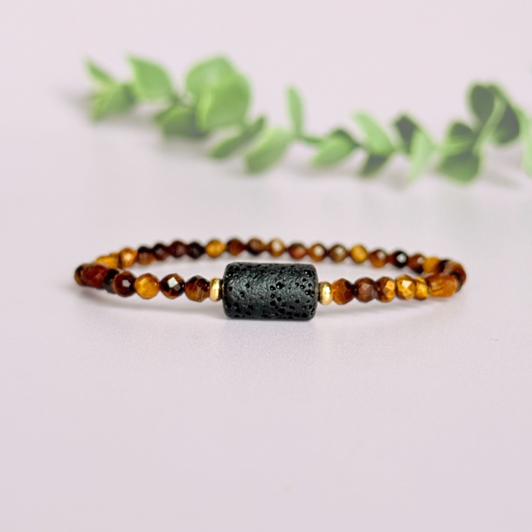 Essential oil diffuser bracelet featuring black lava rock tube bead on the band of 4mm faceted tigers eye beads. Finished with your choice of sterling silver or gold vermeil accent beads.