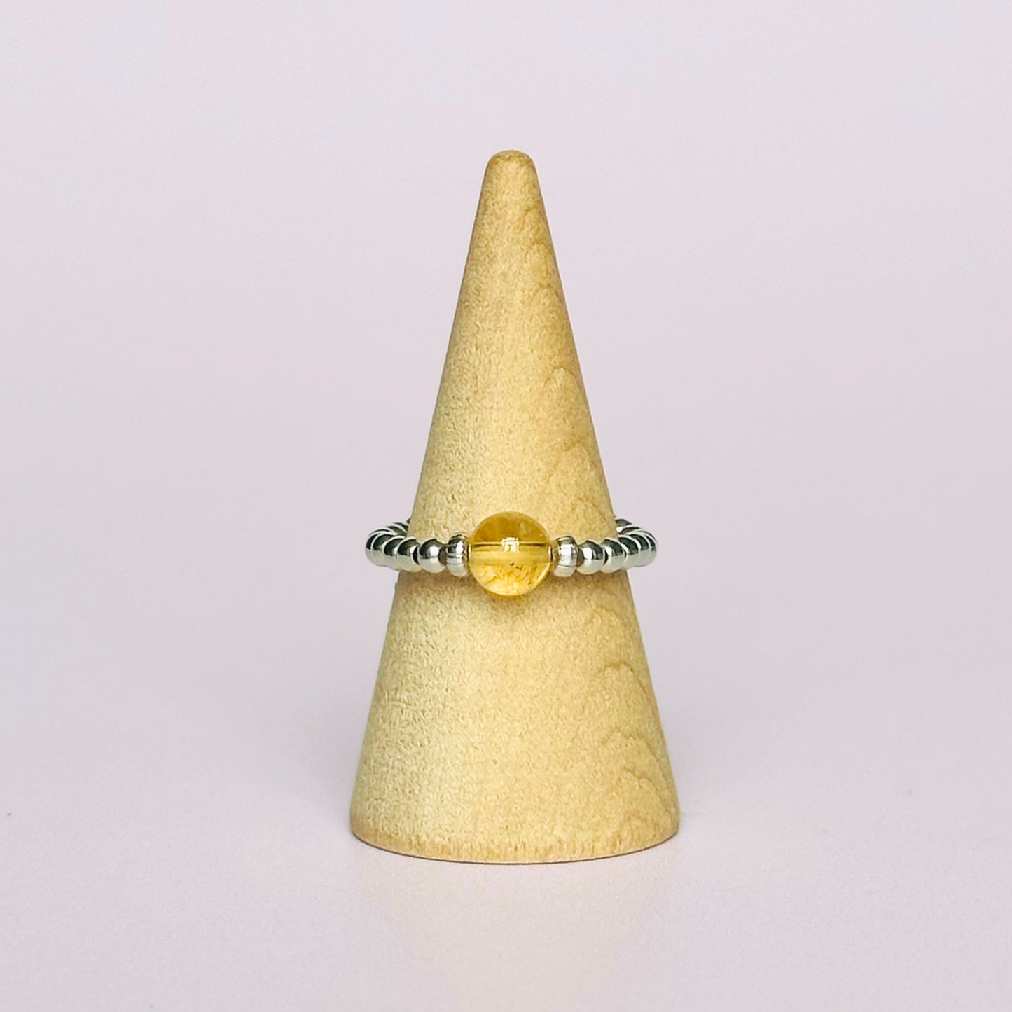 Citrine ring featuring a 6mm round citrine bead, flanked by sterling silver rondelle beads on a sterling silver elasticated band. November birthday ideas, November birthday gift, November birthstone ring, November jewellery, born in November