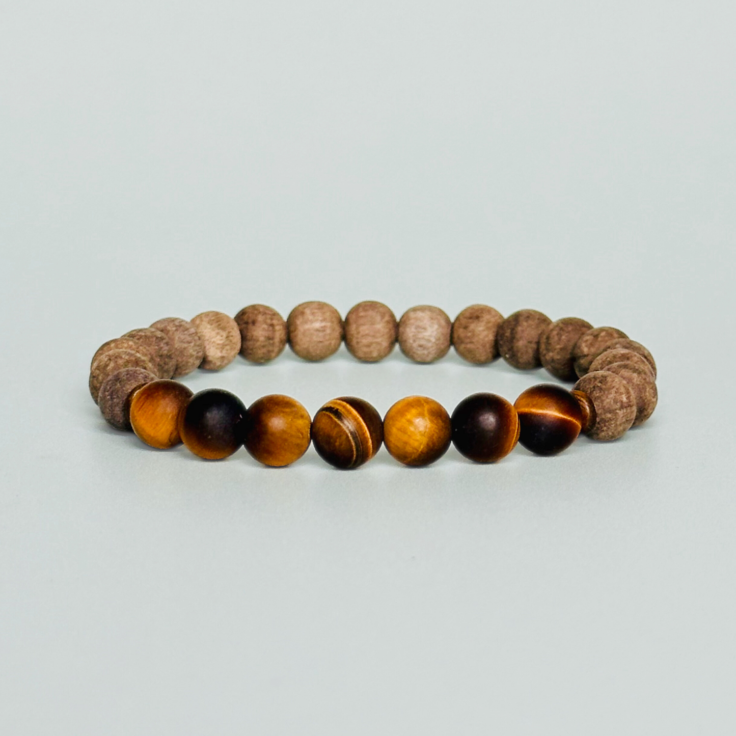 Mens crystal healing bracelet featuring 8mm matte tigers eye beads, sandalwood spacer beads and raw grey wood beads.