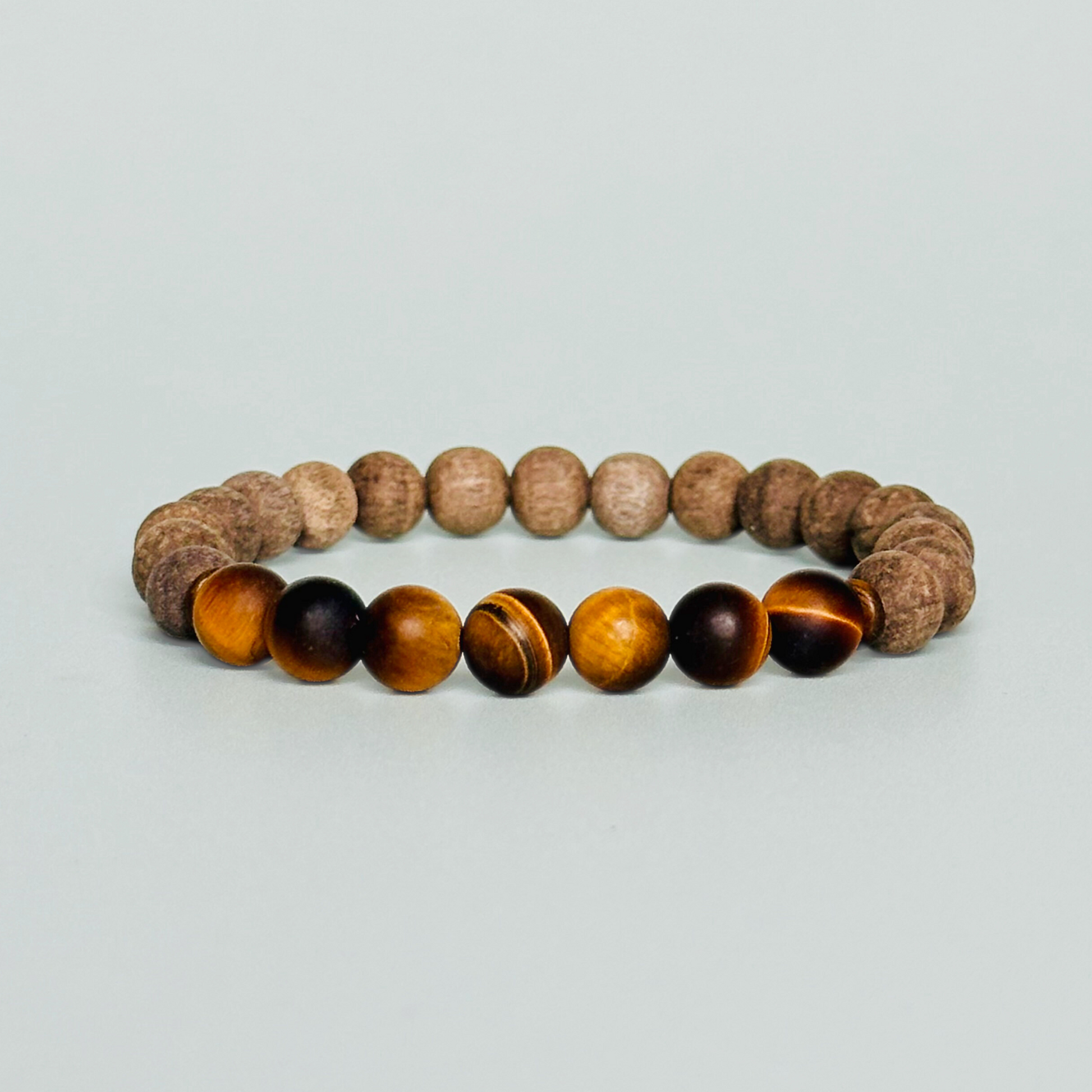 Mens crystal healing bracelet featuring 8mm matte tigers eye beads, sandalwood spacer beads and raw grey wood beads.