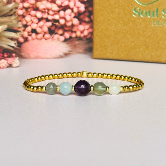 This gold vermeil Aquarius bracelet is made with a selection of five healing crystals all believed to resonate with the Aquarius zodiac sign. The central bead is 8mm, the other four are 6mm. On an elasticated band of 3mm gold vermeil beads with corrugated accent beads. Featuring labradorite, moonstone, fluorite, amethyst and aquamarine.