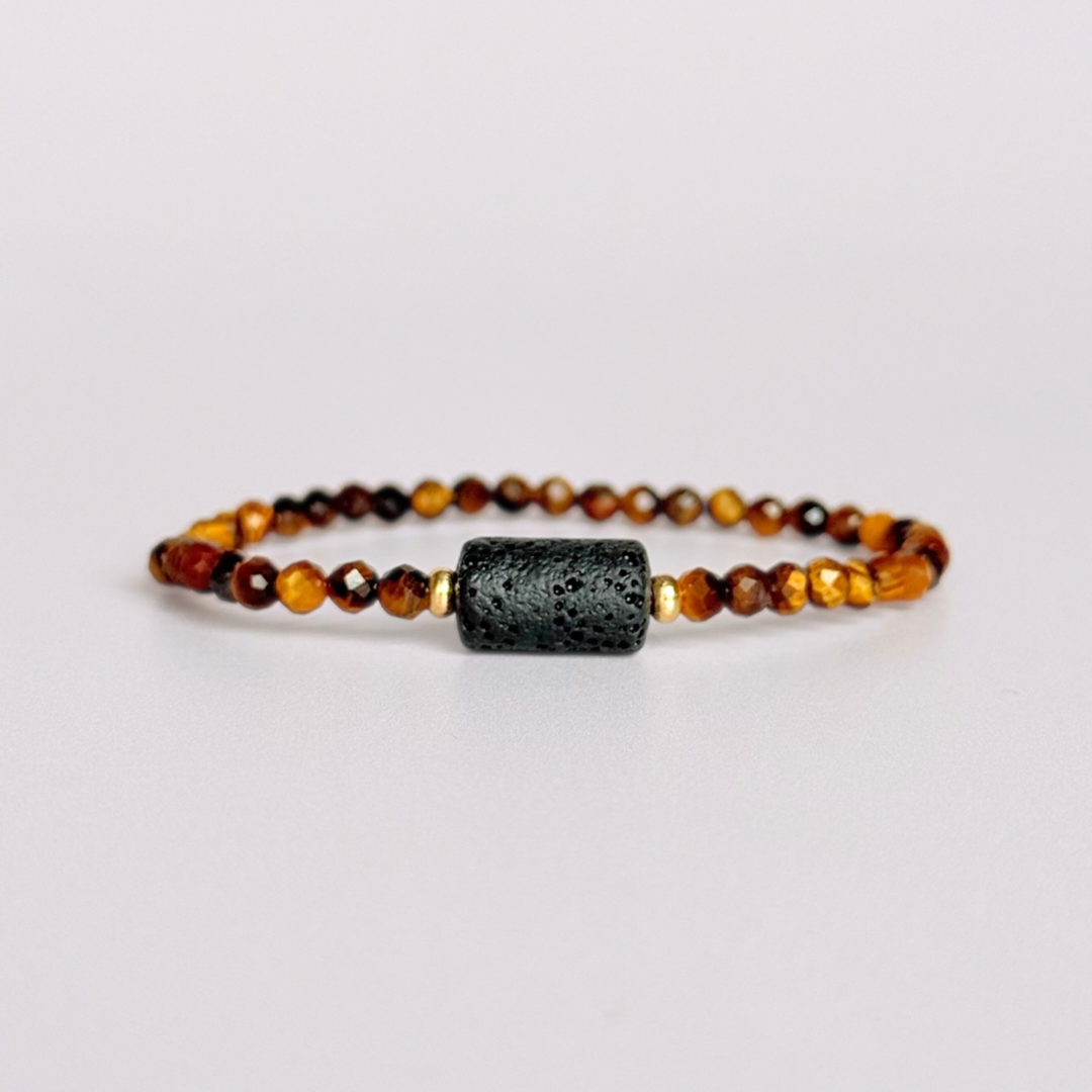 Essential oil diffuser bracelet featuring black lava rock tube bead on the band of 4mm faceted tigers eye beads. Finished with your choice of sterling silver or gold vermeil accent beads.