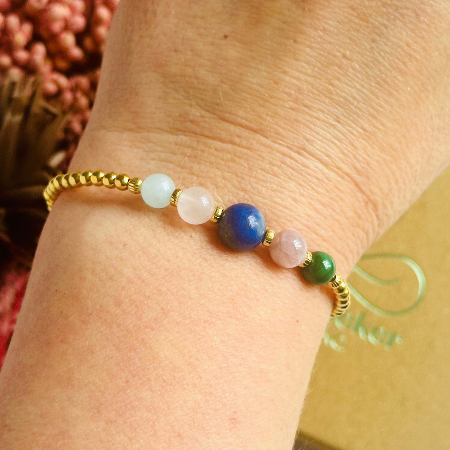 This gold vermeil Taurus bracelet is made with a selection of five healing crystals all believed to resonate with the Taurus zodiac sign. The central bead is 8mm, the other four are 6mm. On an elasticated band of 3mm gold vermeil beads with corrugated accent beads. Featuring malachite, lapis lazuli, rose quartz, kunzite and aquamarine.
