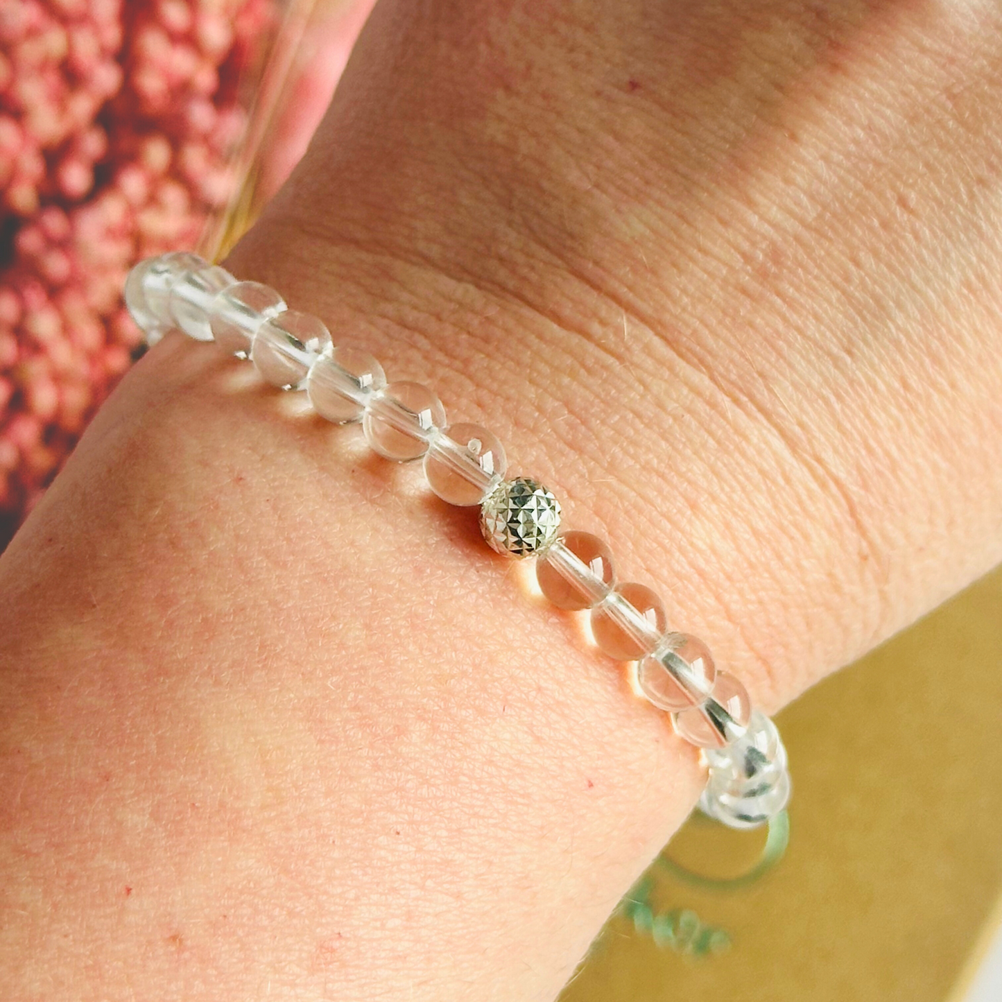 Clear quartz bracelet featuring 6mm round clear quartz beads with either a sterling silver or gold vermeil faceted focal bead