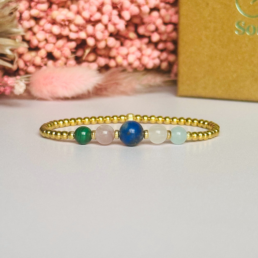 This gold vermeil Taurus bracelet is made with a selection of five healing crystals all believed to resonate with the Taurus zodiac sign. The central bead is 8mm, the other four are 6mm. On an elasticated band of 3mm gold vermeil beads with corrugated accent beads. Featuring malachite, lapis lazuli, rose quartz, kunzite and aquamarine.
