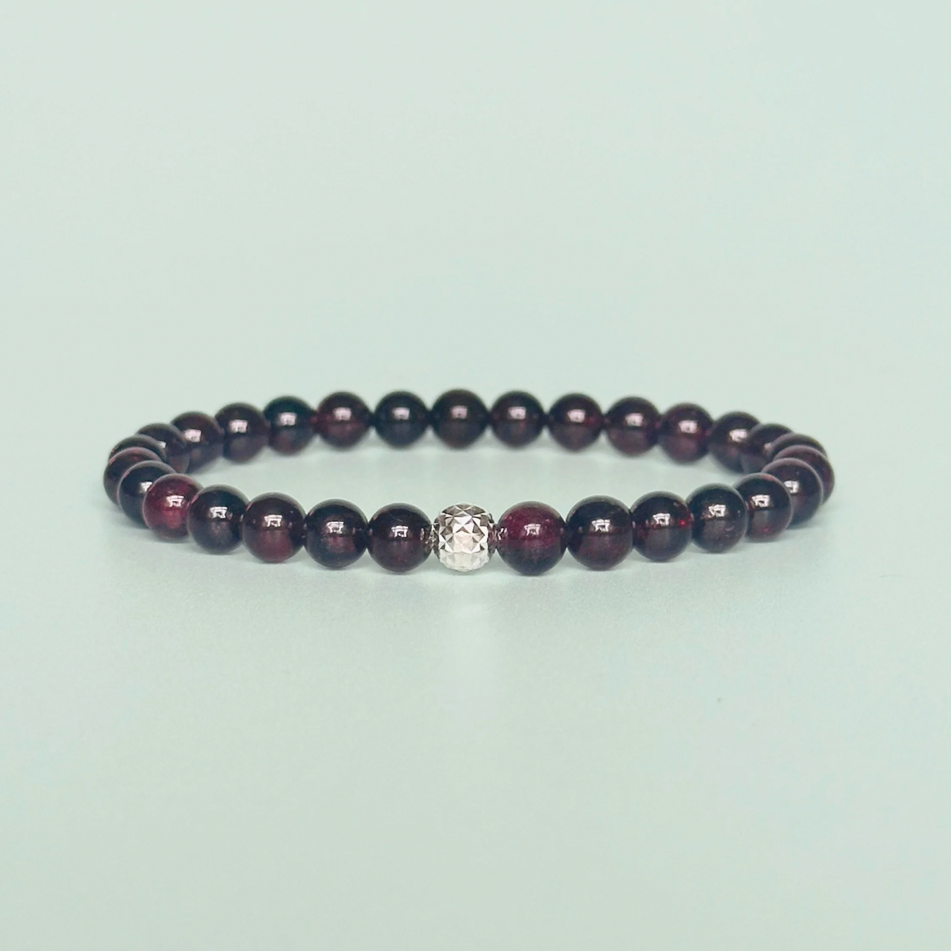 Garnet bracelet with a faceted sterling silver or gold vermeil focal bead. A bracelet for passion, success and confidence. Made with 6mm beads.
